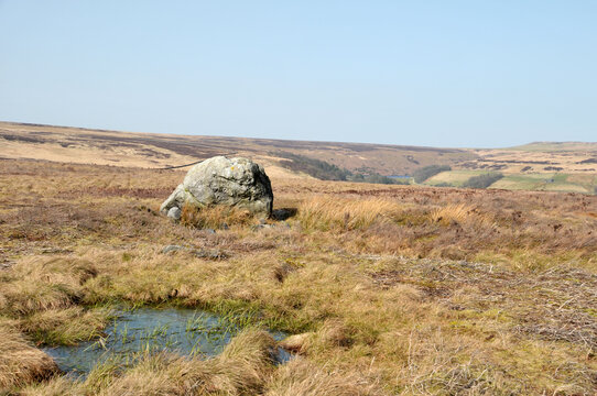 pennine landscape with large old boulder or standing stone on midgley moor in west yorkshire