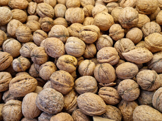 unpeeled walnuts. background and texture. agriculture. supermarket