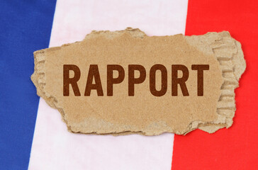 Against the background of the French flag lies cardboard with the inscription - rapport