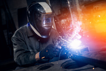 Welder work with metal parts car in factory, sparks and electricity