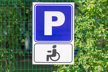 Disabled parking sign on the fence.