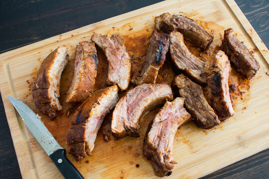 Barbecue Baby Back Ribs on a Bamboo Cutting Board: Pork  back ribs on a wooden carving board