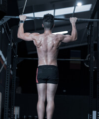 
young man training inside a gym with functional exercise.
athlete body