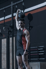 Fototapeta na wymiar young man training inside a gym with functional exercise. athlete body