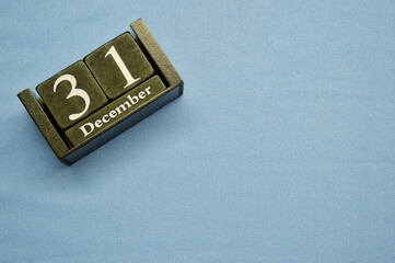 Wooden calendar from blocks on a blue background with copy space. 31st December