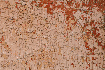 Texture of peeling paint on old wooden rustic material on the wall.