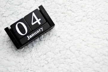 Wooden calendar from blocks on white background with copy space. 4th of January