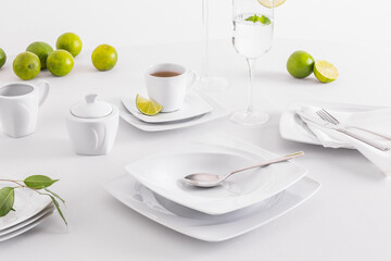 Minimalist white porcelain composition with lemons and avocado