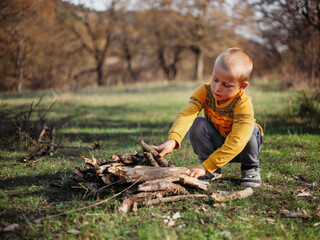A little boy making bonfire