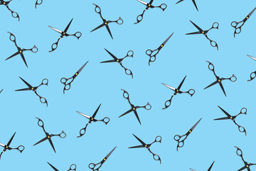 Background of black scissors. professional hairdresser black scissors isolated on blue. Black barber scissors, close up. pop art background, for prints or posters. not seamless pattern