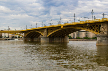 Fototapeta na wymiar The yellow Margaret Bridge over the Danube River in Budapest, Hungary