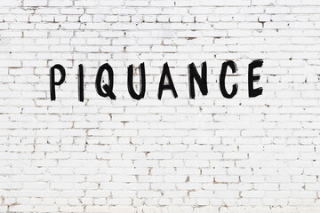 Inscription piquance painted on white brick wall - obrazy, fototapety, plakaty