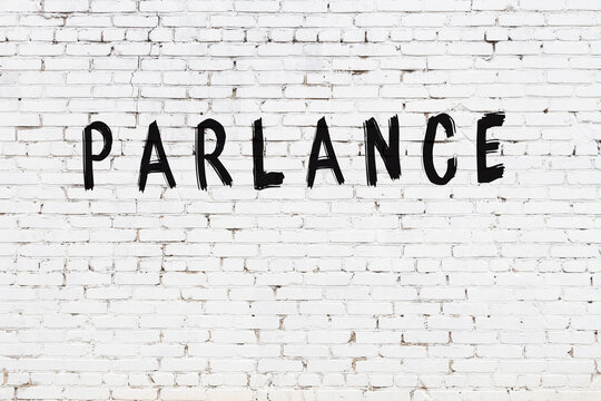 Inscription parlance painted on white brick wall