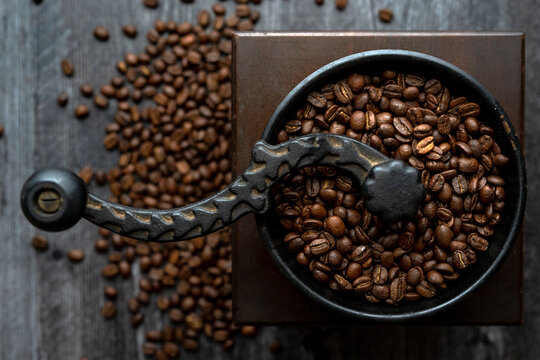 Overhead of coffee beans in hand grinder