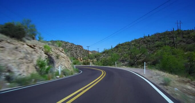 Driving on a curvy winding Apache Trail Arizona desert scenic road on way to Canyon Lake pulling over allowing 3 vehicles to pass.