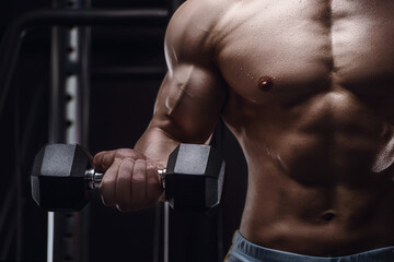 Close up body of athletic man in the gym