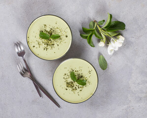 Panna Cotta green matcha tea in a glass bowl on a light gray background top view