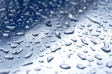 Many different drops of water on the metal surface