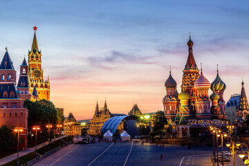 Colorful sunset over the Kremlin wall towers and St. Basil Cathedral at the Red Square. Summer sunset in Moscow, Russia