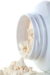 Protein powder in a plastic container on a white background.