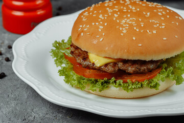 hamburger with fries and salad on the plate