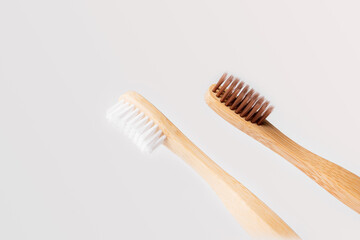 two wooden toothbrushes on light background