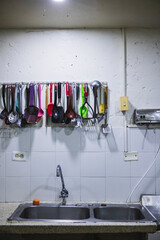 Closeup shot of spoons hanging from a wall in a kitchen