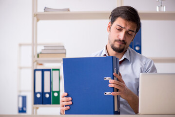 Young male employee working in the office