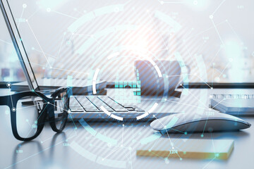Encircled keylock hologram icon with a laptop and glasses in the background, data safety and...