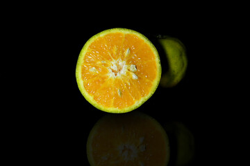 fresh ripe cut orange on a black background