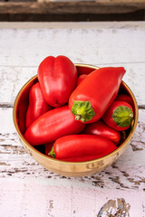 45 degree view of spectacular red bell peppers in metal bowl