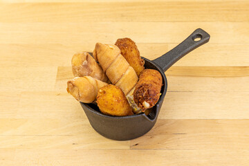 different flavored tequeños in a nice black cast iron