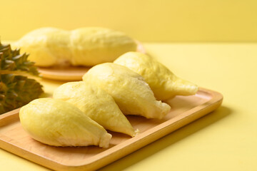 Ripe Thai durian fruit (Monthong) on plate with yellow background, Tropical fruit
