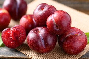 Close up of fresh Japanese or Chinese plum fruit on wooden background