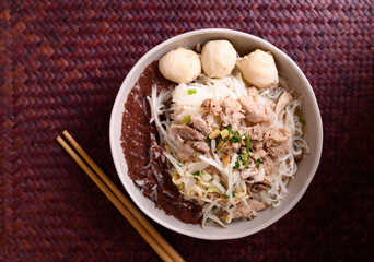 Rice noodle soup with pork, pork ball and vegetables in a bowl and chopstick, Thai noodles soup