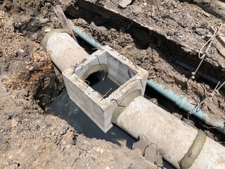 Construction sit of concrete sewer in street side. Basic development infrastructure plan of transport city system.  