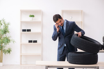 Young man selling tires in the office