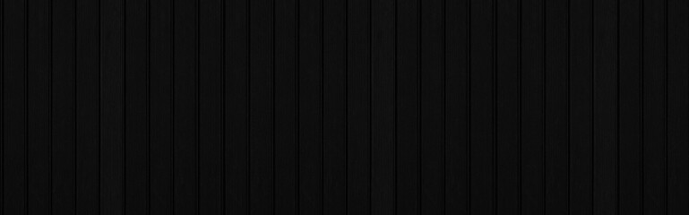 Panorama of New Black vintage wooden wall texture and background seamless or a black wooden fence