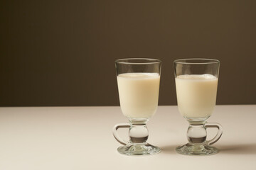 Healthy fresh milk, on white table and dark background.