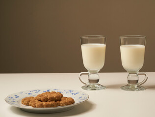Healthy fresh milk and cookies, on white table and dark background.