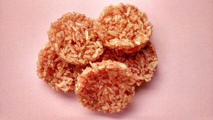 Indonesian thick rice cracker, made from cooked glutinous sticky rice and seasoned with spices, made into a flat and rounded shape, and then sun dried. Crispy rice cracker and salty taste