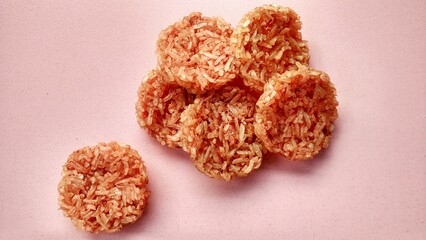 Indonesian thick rice cracker, made from cooked glutinous sticky rice and seasoned with spices, made into a flat and rounded shape, and then sun dried. Crispy rice cracker and salty taste