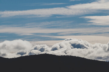 beautiful sky with clouds rolling over the mountains in Tasmania, Australia