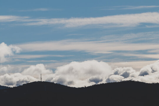 beautiful sky with clouds rolling over the mountains in Tasmania, Australia