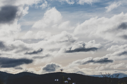 beautiful sky with clouds rolling over the mountains in Tasmania, Australia