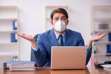 Young businessman employee working in the office during pandemic