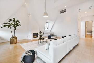 Contemporary minimalist interior design of lounge zone with couches and carpet in attic open space...