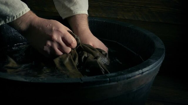 Man Washing Shirt In Tub Historical Setting