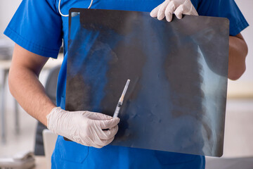 Young male doctor radiologist working in the clinic during pande