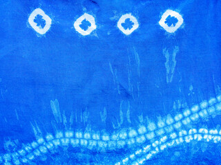 Indigo blue fabric tie dye pattern background. Indigo-Dyed fabric texture with abstract ethnic graphic motif pattern.